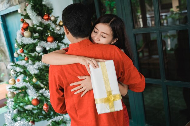 Famiglia felice asiatica che celebra il Natale insieme a casa