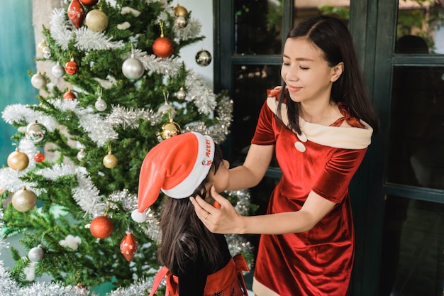 Famiglia felice asiatica che celebra il Natale insieme a casa