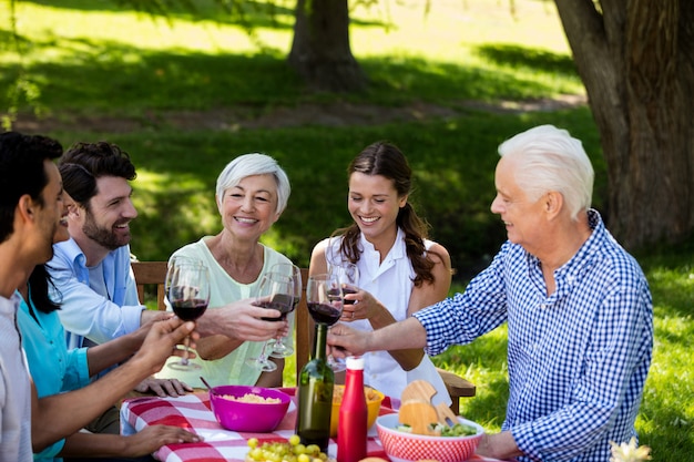 Famiglia felice che tosta un bicchiere di vino