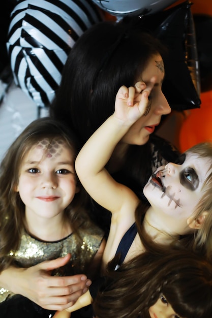 Famiglia felice con bambini in costume e trucco per la celebrazione di Halloween