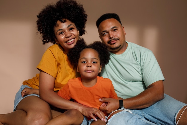 Famiglia nera di vista frontale che posa nello studio