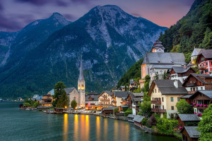 Foto famoso villaggio di hallstatt nelle alpi e nel lago al tramonto vecchia architettura austria viaggio europeo