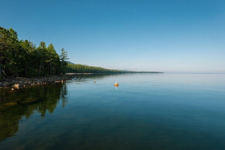 Fantastic panorama of Lake Baikal at sunset is a rift lake located in southern Siberia, Russia. Baikal lake summer landscape view. Drone's Eye View.