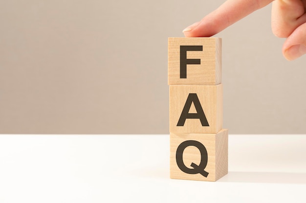 FAQ  letters abbreviation on wooden cubes on a gray background