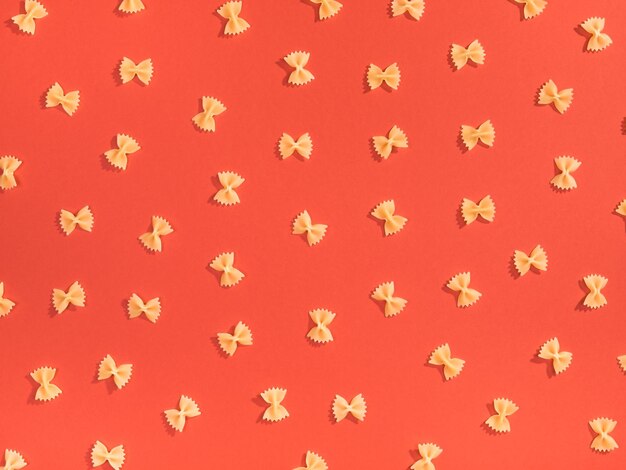 Farfalle pasta random flat lay pattern su sfondo rosso