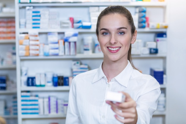 Farmacista che mostra una medicina in farmacia