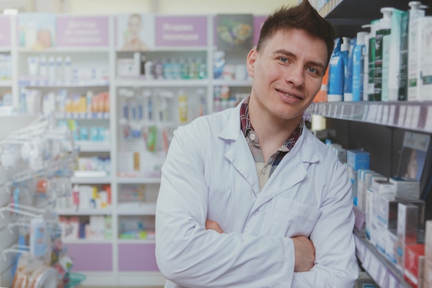 Farmacista maschio bello che lavora alla sua farmacia