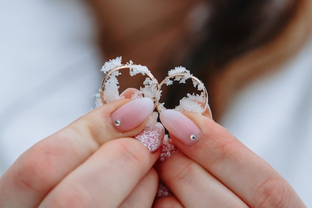 Fedi nuziali nella neve Fedi nuziali nelle mani della sposa