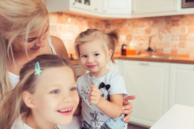 Felice amorevole giovane famiglia di madre e le sue due piccole figlie