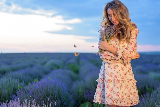 Felice donna bionda in campo di lavanda