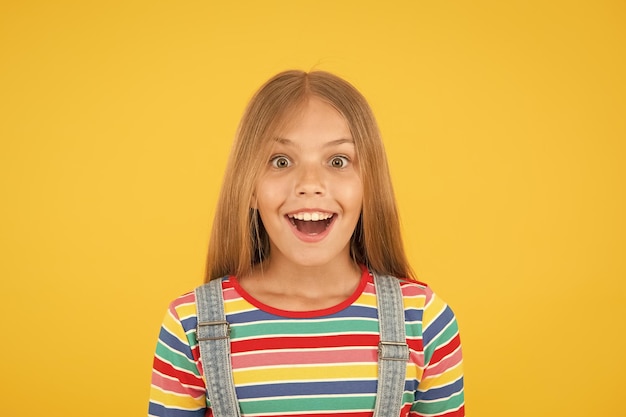 Felice giorno dei bambini infanzia felicità allegro hipster ragazza vestiti colorati ottimista concetto piccola ragazza sfondo giallo estate capretto moda capretto umore positivo Bambino felicità ritratto