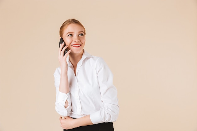 Felice giovane donna d'affari parlando dal telefono cellulare.