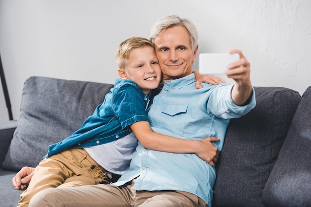 Felice nonno e nipote che prendono selfie sullo smartphone