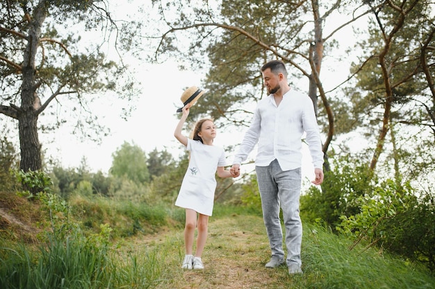 Felice padre e figlia che giocano mentre camminano in un bellissimo parco estivo Padre ideale per il fine settimana con la sua piccola figlia