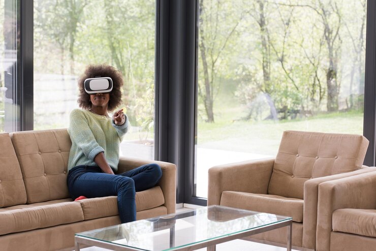 Foto felice ragazza afroamericana che fa esperienza usando gli occhiali vr della realtà virtuale a casa