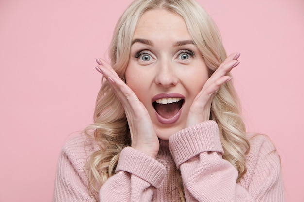 Felice volto di donna sorpresa in maglione di lana. Avvicinamento