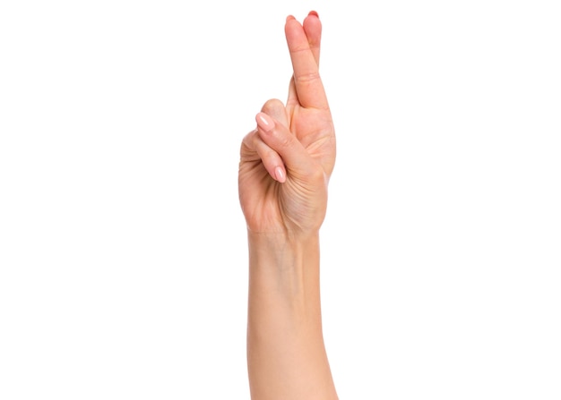 Female hand showing crossing fingers gesture isolated on white background with copy space