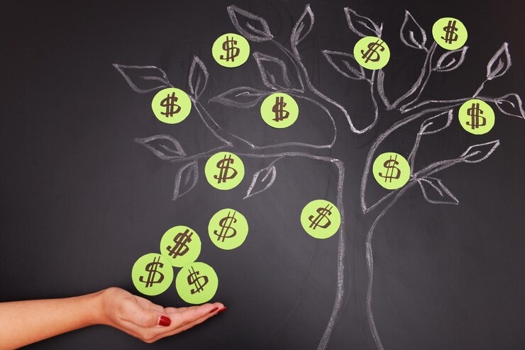 Photo female hand with chalk dollar tree drawing on blackboard background