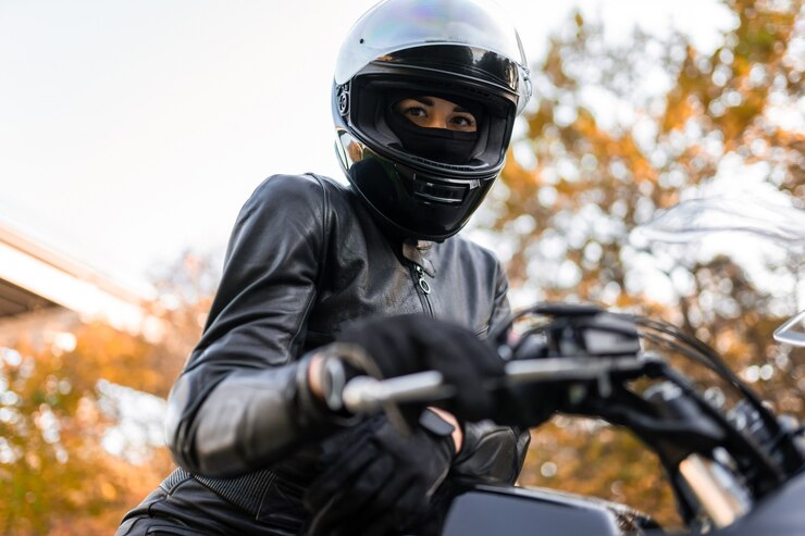 Female motorcyclist in helmet