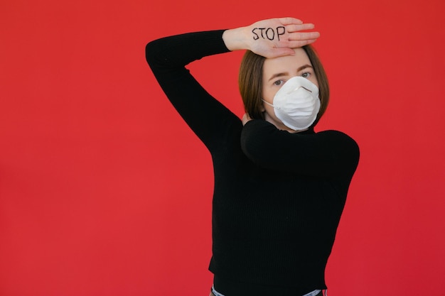 Fermare il virus e le malattie epidemiche Donna sana in maschera protettiva medica che mostra l'arresto del gesto