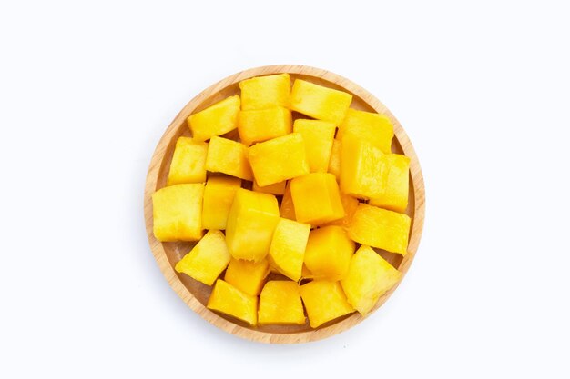 Fette di cubo di mango giallo in piatto di legno