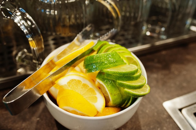 Fette di limone e lime in una ciotola per cocktail