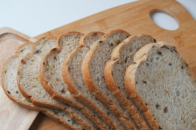 Fette di pane su un tagliere con un buco a forma di cuore nel mezzo.