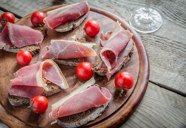 Fette di prosciutto italiano sul bordo di legno