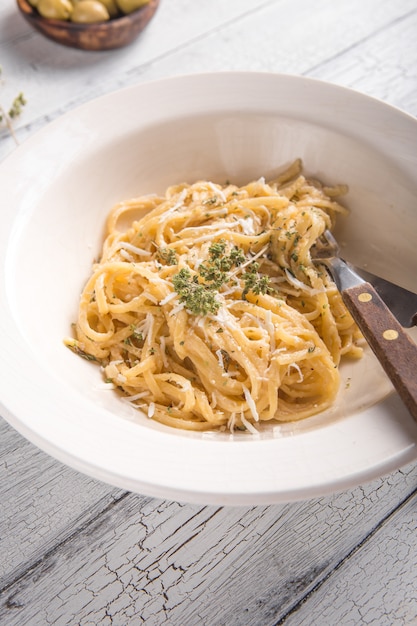 Fettucini Alfredo in un piatto con olive