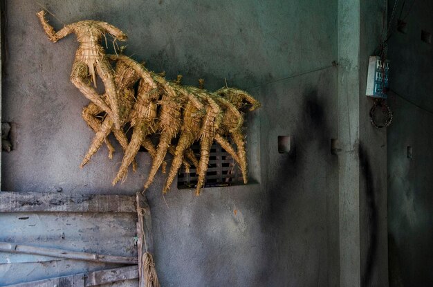 Figurine umane fatte di paglia contro il muro