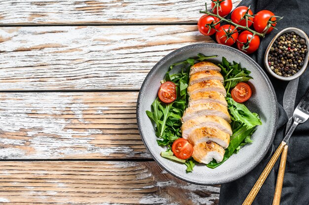 Filetto di petto di pollo alla griglia con insalata di rucola.