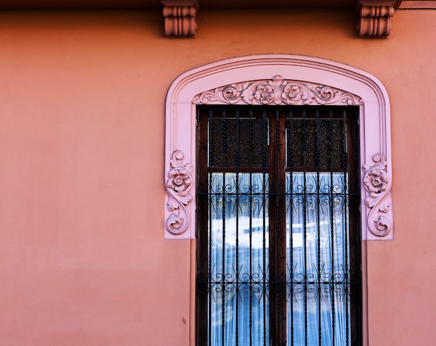 finestra con finiture rosa sul muro rosa