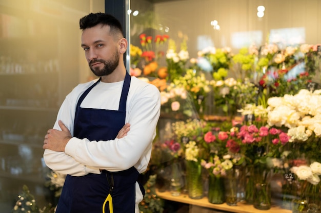 fioraio esperto accanto al frigorifero con mazzi di fiori.