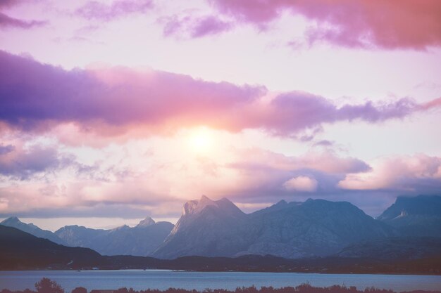 Fiordo al tramonto drammatico Litorale roccioso la sera Bella natura della Norvegia