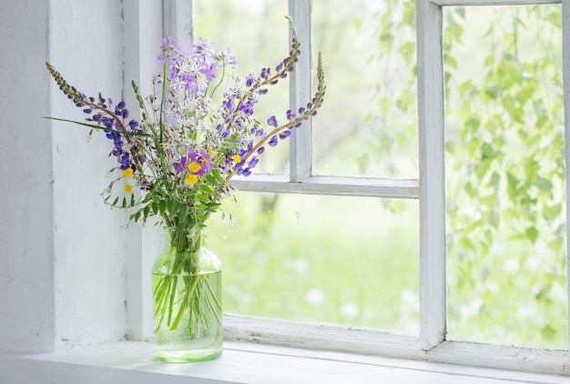 Fiori selvatici in vaso sul davanzale bianco