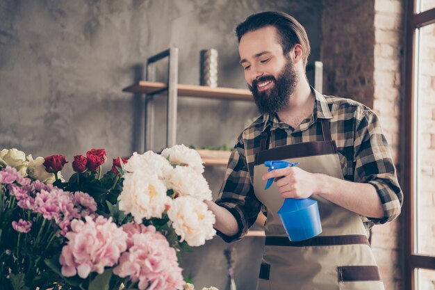 fiorista barbuto che lavora nel suo negozio di fiori