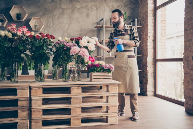 fiorista barbuto che lavora nel suo negozio di fiori