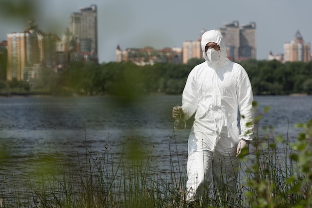 Focus selettivo dell'ispettore dell'acqua nel respiratore del costume protettivo e negli occhiali che tengono il pallone con