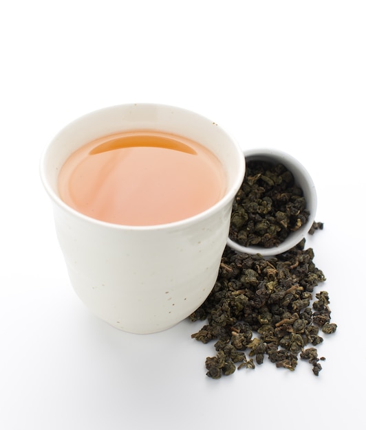 Foglie di tè asciutte del oolong su fondo bianco