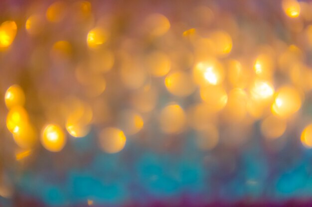 Fondo astratto di Natale con le luci defocused del bokeh dell&#39;oro