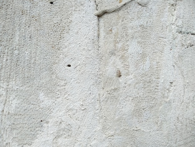 Fondo astratto di struttura del muro di cemento poroso, incrinato e stagionato