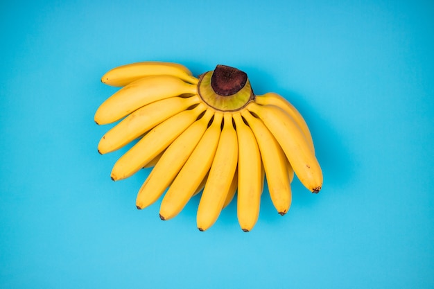 Fondo astratto tropicale delle banane gialle fresche di frutti sul blu