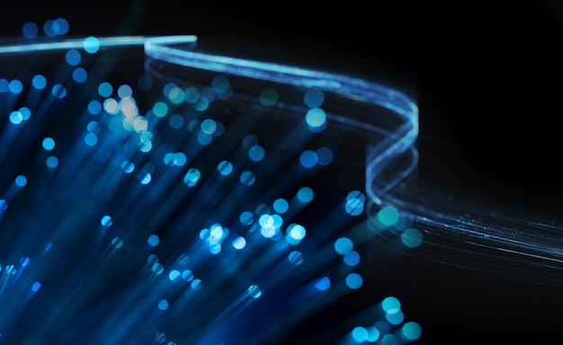 Fondo blu astratto del Internet con luce di fibra ottica