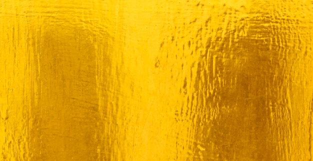 Fondo brillante di struttura della stagnola di oro della foglia gialla