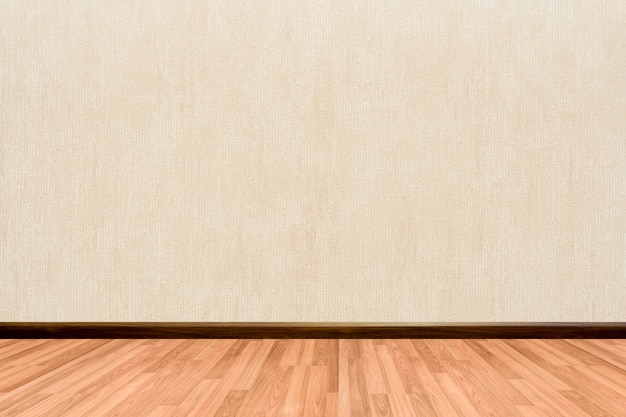 Fondo della stanza vuota con crema per pavimenti in legno o carta da parati beige.