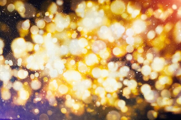 Fondo festivo astratto. Sfondo di luci vintage glitterato con luci sfocate. Fondo del bokeh di festa di Natale e Capodanno con copyspace.