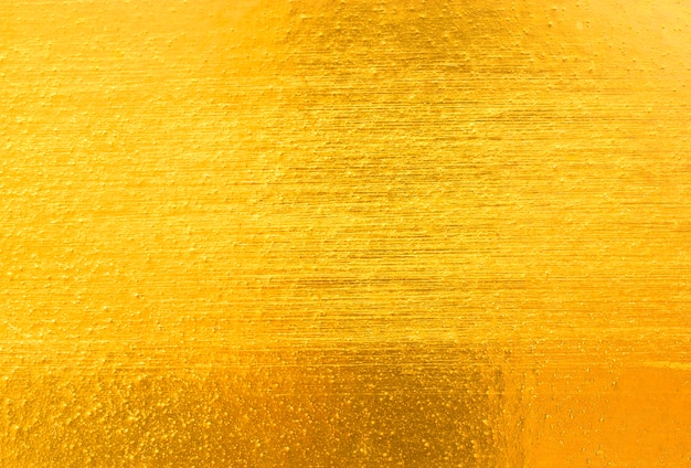 Fondo giallo brillante di struttura della stagnola di oro della foglia