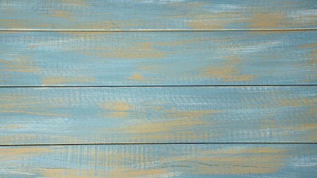 Fondo in legno blu con elementi in oro.