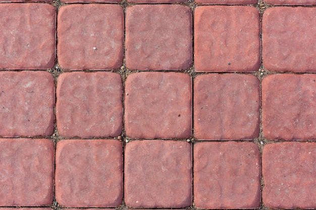 Fondo rosso di struttura delle mattonelle del calcestruzzo