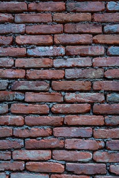 Fondo rosso di vecchia struttura del muro di mattoni dell'annata. Vista ravvicinata del vecchio muro di mattoni in pietra con muratura medievale, Foto di alta qualità